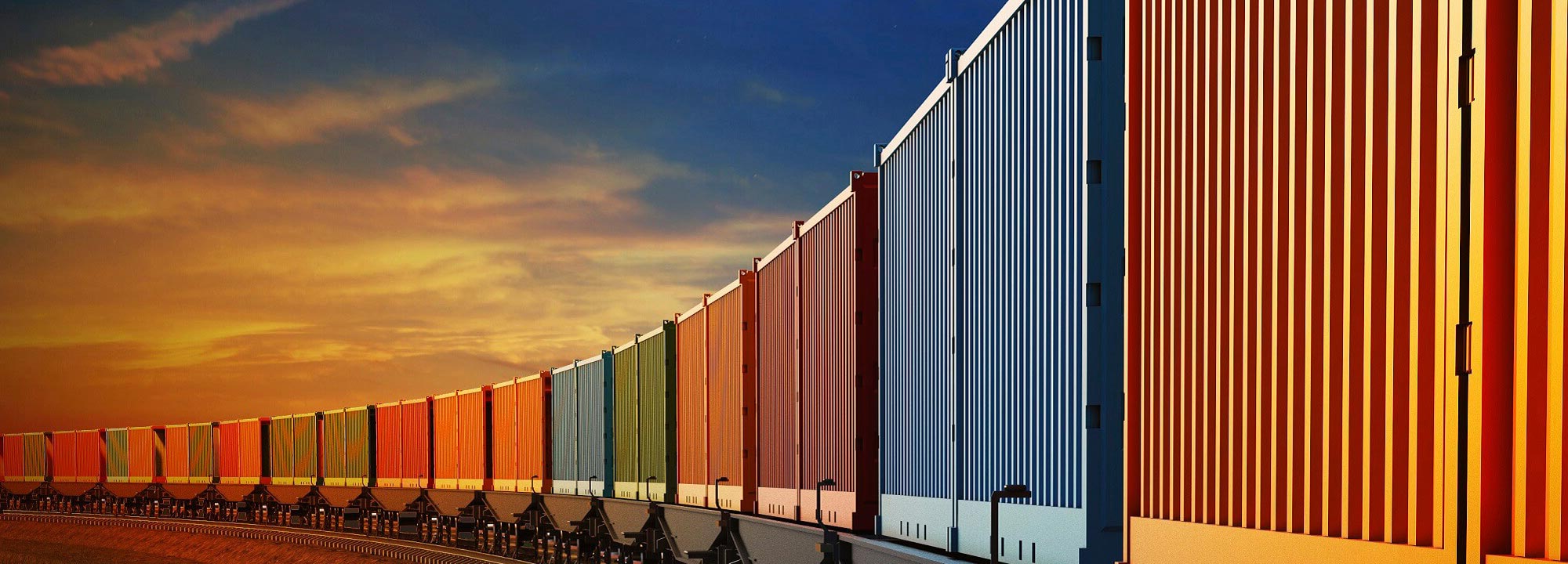 A train of multi-coloured containers curving into the distance with an orange sunset