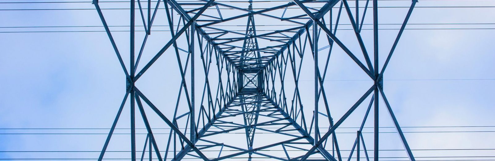 Looking directly up at an electricity pylon from below
