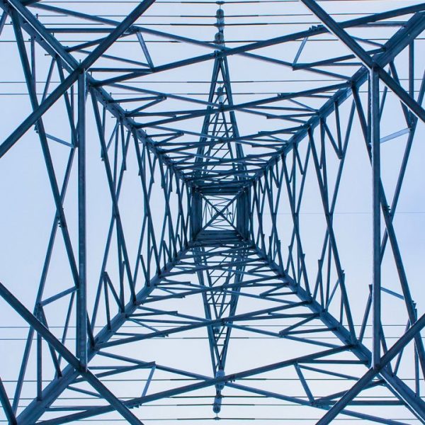 Looking directly up at an electricity pylon from below