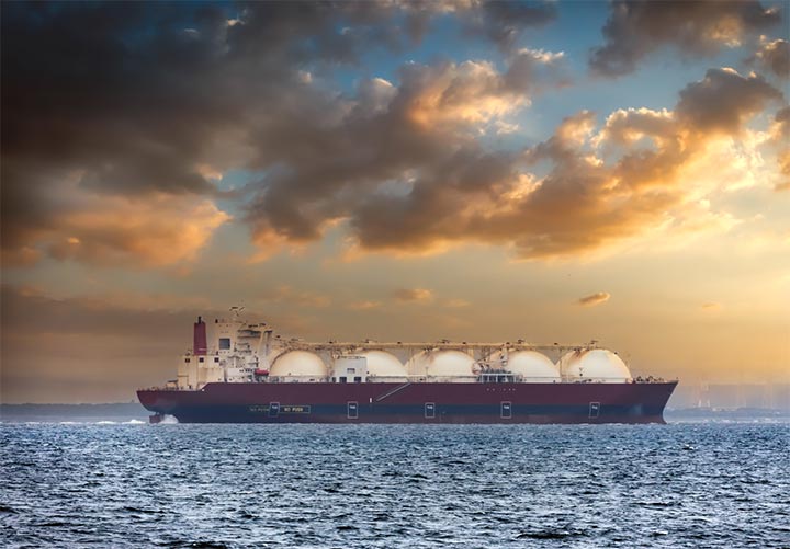 Oil tanker ship on the sea with a sunset in the background