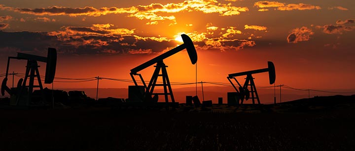 Silhouette of oil refinery at sunset