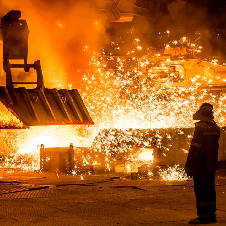 Steel processing factory interior with sparks