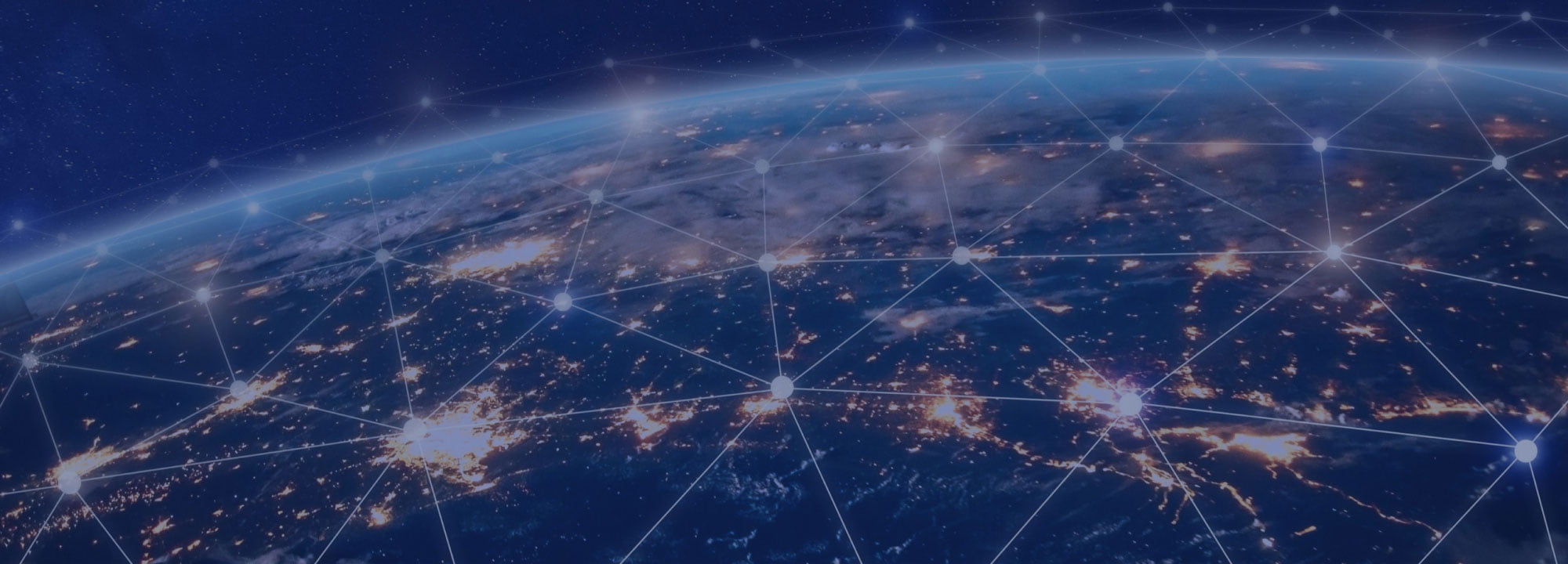 Photograph of the globe from space showing cities lit up at night and connected with lines