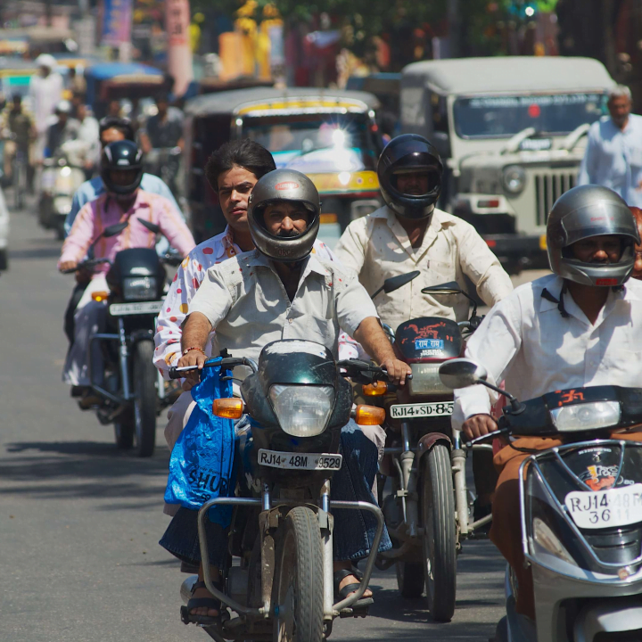 A picture of men on motorbikes in India to illustrate the scale of the transportation in the country.