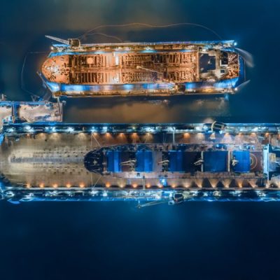 An overhead image of docked tankers refuelling at night