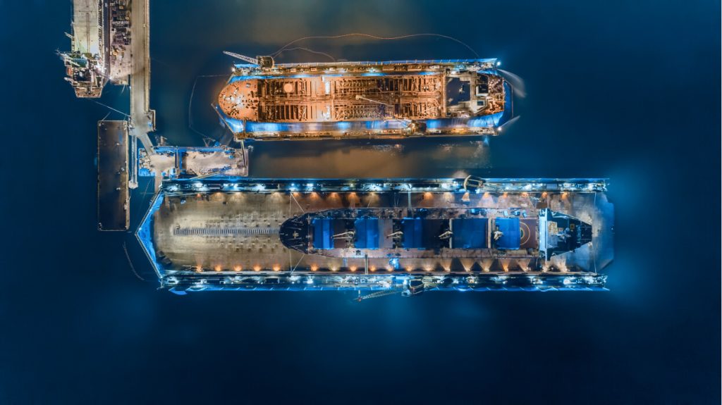 An overhead image of docked tankers refuelling at night